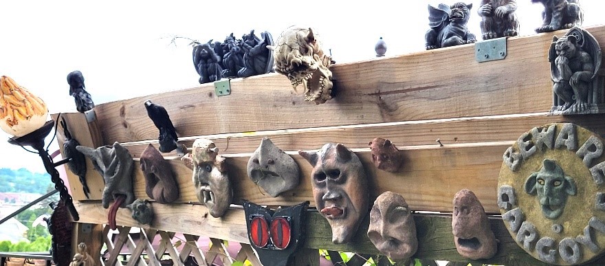 Homemade cement sculptures, collected garden decor, and torch light.